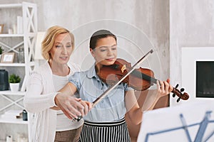 Professional violinist teaching her student