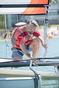 Professional waterman training on lake with catamaran