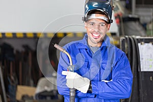 Professional welder posing with wellding machine