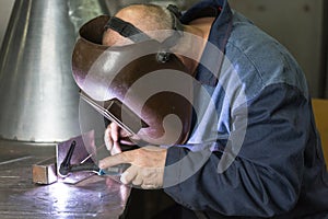 Professional welder welding metal parts