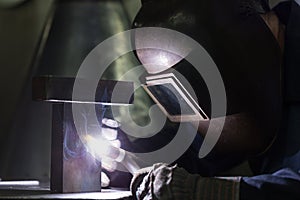 Professional welder welding metal parts