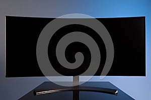 professional widescreen curved gaming monitor close-up on gray-blue stylish background