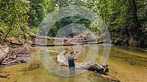 Professional wildlife photographer taking photos in the river tropical jungle forest in Gunung Mulu National park. Sarawak.