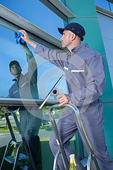 Professional window cleaner at work outdoors