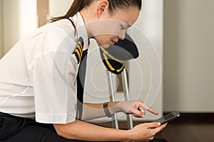 Professional woman checking her phone at work