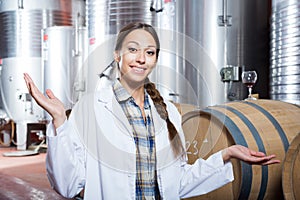 Professional woman checks the wine at factory