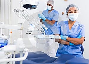 Professional woman dentist with arms crossed at dental clinic