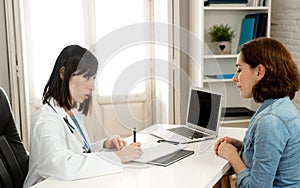 Professional woman Doctor having consultation showing test results on laptop to inform patient