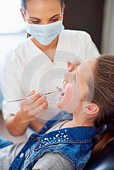 Professional woman, girl and dentist with tools in hands for teeth check, hygiene and healthcare. Young patient, female