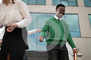 Professional woman guiding a businessman outdoors in the city