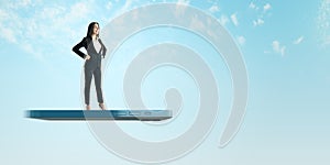 A professional woman in a suit stands confidently on a giant smartphone, symbolizing connectivity