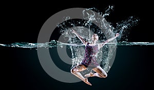 Professional woman swimmer on a wave