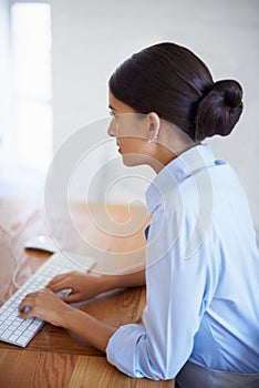 Professional, woman and typing at desk in office with computer as assistant in administration Business, clerk and