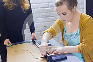 Professional women decorators working with kraft paper