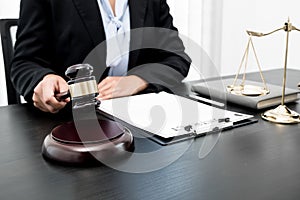 Professional women lawyers work at a law office There are scales, Scales of justice, judges gavel, and litigation documents.
