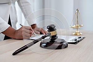 Professional women lawyers work at a law office There are scales, Scales of justice, judges gavel, and litigation documents.