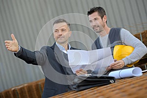 professional worker holding blueprint