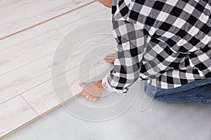 Professional worker installing new laminate flooring, closeup