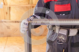 Professional worker man holding new window frame