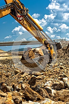 Professional worker moving excavator scoop