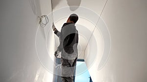 Professional worker with sandpaper prepare wall for painting