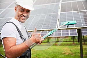 Professional worker showing his good job of cleaning solar panel.