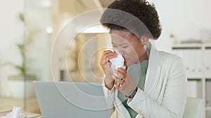 Professional worker suffering from flu symptoms, allergy or sinus, coughing and wiping her nose at her work. Young