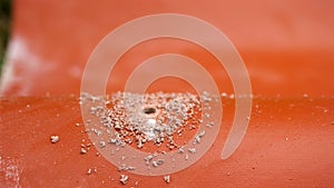 The professional worker using drill to make a hole in a red roof tile, construction concept. Stock footage. Industrial