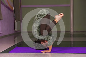 Professional yoga trainer practicing yoga lesson in a studio