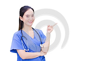 Professional young Asian woman doctor wearing blue uniform and stethoscope standing while pointing to the top with happy and smile