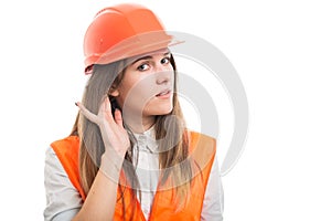 Professional young builder woman listening something