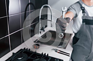 Professional young chef cook in uniform standing and preparing for the work on kitchen