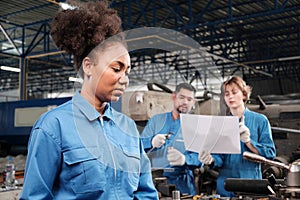 Professional young female worker works in metalwork manufacturing factory