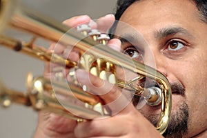 Young man playing trumpet in studio