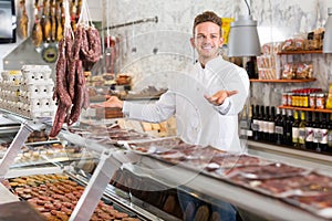 Professional young seller at butcher market