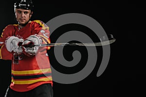 professional young sportsman holding hockey stick