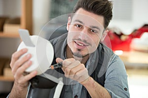 professional young worker fixing coffee machine