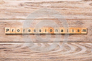 Professionalism word written on wood block. Professionalism text on wooden table for your desing, concept photo