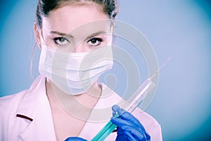 Professionalist in mask with syrigne photo