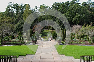 Professionally landscaped garden terraces, flagstone pathways edged by a grove of trees in North Carolina