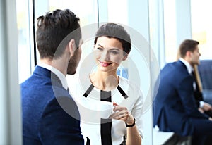 Professionals chatting during a coffee break