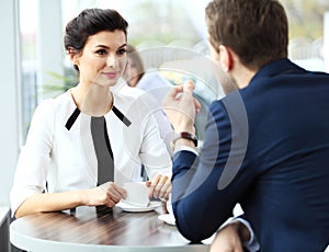 Professionals chatting during a coffee break