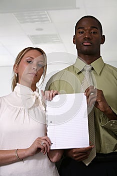 Professionals holding blank white notebook