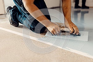 Professionals in the installation of epoxy resin floors apply a non-slip flooring system