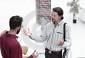 Professionals speak, standing in the office