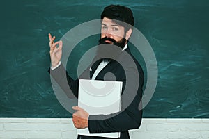 Professor in class on blackboard background. Chalkboard copy space. Teachers day.