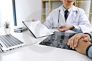 Professor Doctor having conversation with patient and holding x-ray film while discussing explaining symptoms or counsel diagnosis