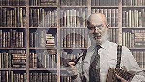 Professor posing in the library with books