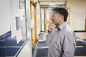 Professor reading notice board