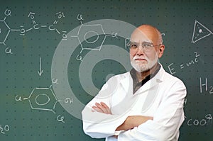 Professor stands in front of a blackboard